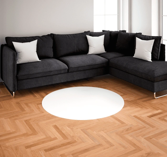 Modern Herringbone Wood Floor in Florida Living Room – A&K Flooring Elegant herringbone wood flooring under a black sectional sofa with white pillows in a sunlit Florida living room